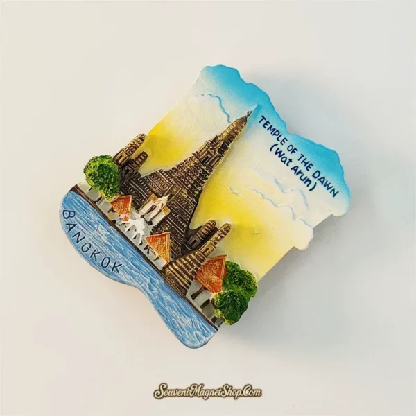 Bangkok Wat Arun souvenir magnet tilted angle view showing 3D depth and sculpted temple detail