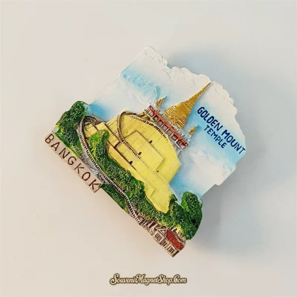 Angled left view of Bangkok Golden Mount Wat Saket souvenir magnet showing 3D hill stairway and golden spire