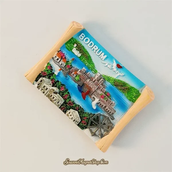 Angled view of hand-painted Bodrum Turkey scroll magnet showing 3D relief castle and harbor scene