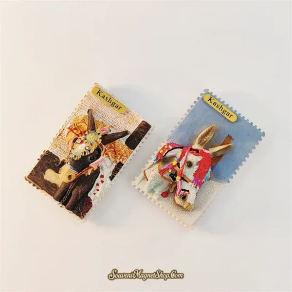 Angled view of Kashgar donkey fridge magnet pair showing 3D relief depth with brown donkey and white donkey side by side