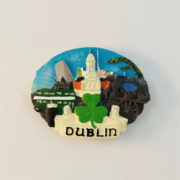 Front view of Ireland Dublin oval fridge magnet with shamrock, Spire, City Hall, Dublin Bus and Famine Memorial in 3D relief