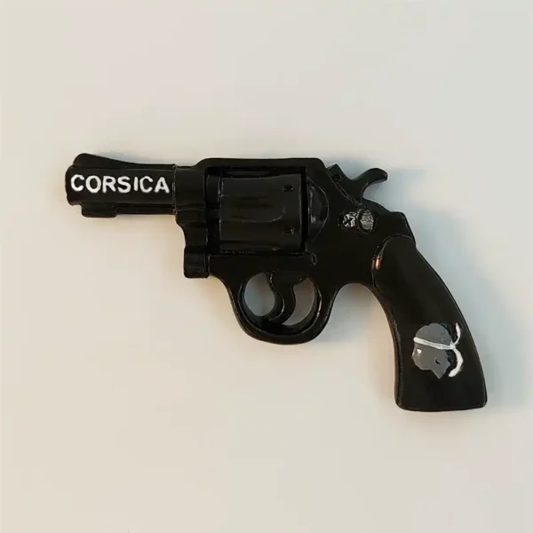 Front view of France Corsica revolver fridge magnet with white CORSICA lettering on barrel and Moor's Head emblem on grip