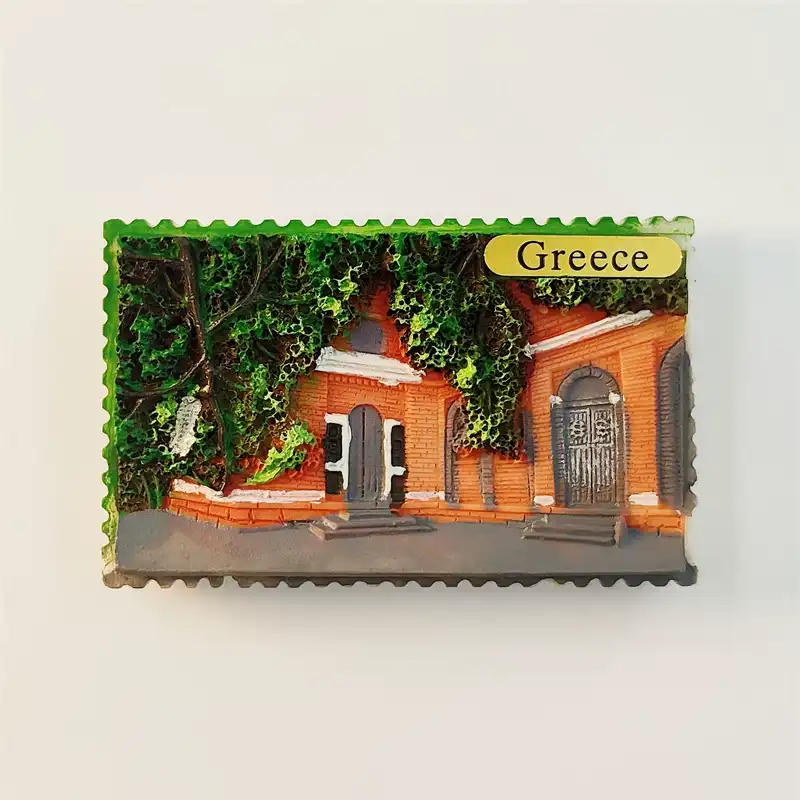 Greece fridge magnet front view postage stamp shape with 3D terracotta brick village guesthouse arched doorways dark wooden iron doors lush green ivy climbing vines covering upper wall gray cobblestone street yellow Greece oval label top right