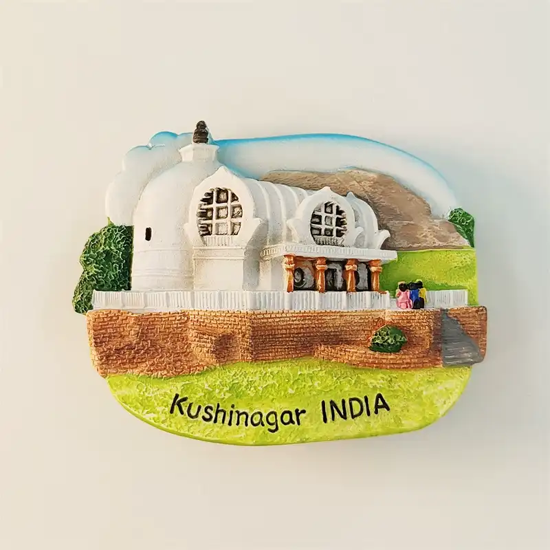 India Kushinagar fridge magnet front view featuring Mahaparinirvana Temple white stupa dome, pillared entrance with round windows, green lawn, brick base and Kushinagar INDIA text