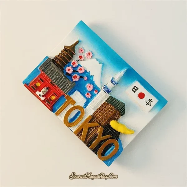 Japan Tokyo souvenir fridge magnet angled left view showing 3D sculpted Senso-ji Temple, cherry blossoms, Mt. Fuji and Tokyo Skytree with gold TOKYO text