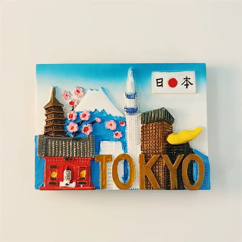 Japan Tokyo fridge magnet front view featuring Senso-ji Temple pagoda, Mt. Fuji, cherry blossoms, Tokyo Skytree and gold TOKYO lettering on blue sky background