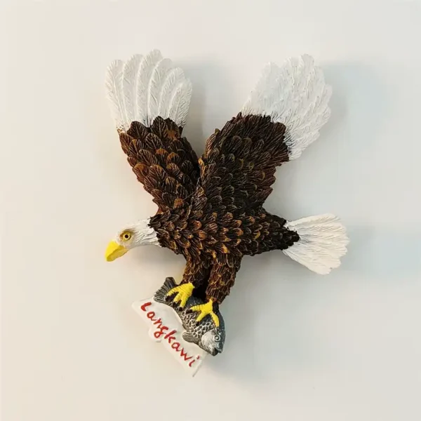 3D Langkawi eagle fridge magnet front view, wings spread, brown feathers, yellow beak gripping fish with Langkawi label