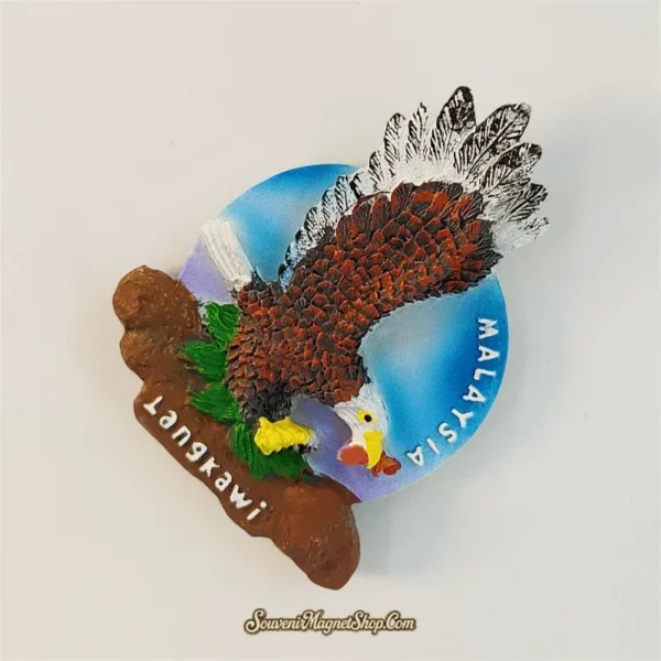Angle view of the Malaysia Langkawi eagle souvenir magnet showing sculpted feather texture and the island's iconic Dataran Lang motif