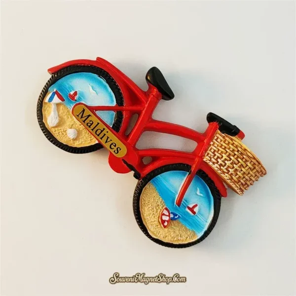 Maldives bicycle souvenir magnet left angle showing 3D relief depth of rattan basket and beach wheel scenes