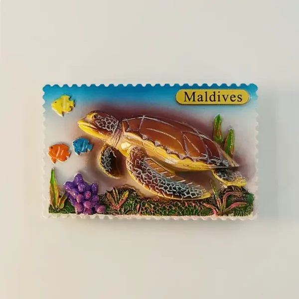 Front view of 3D Maldives sea turtle fridge magnet in stamp shape with coral reef and tropical fish