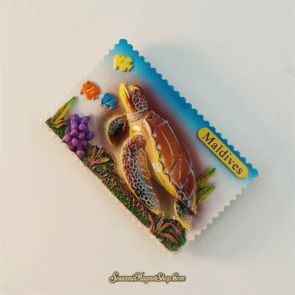 Left angle of Maldives sea turtle souvenir magnet showing 3D underwater scene with coral and seaweed