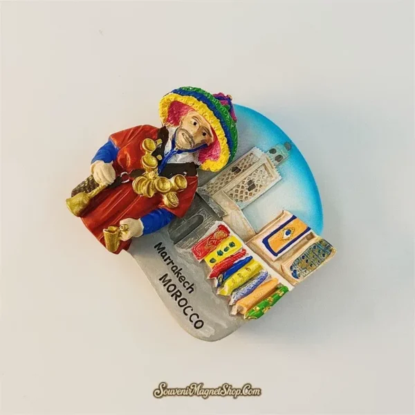 Left-angle view of Marrakech Morocco Guerrab water seller souvenir magnet showing 3D figure detail and market stall