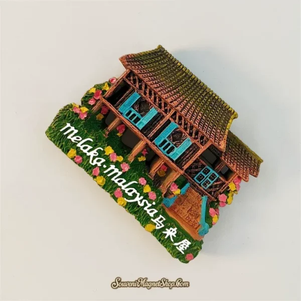 Angled view of hand-painted Melaka Malaysia Malay house magnet showing 3D timber frame and roof detail