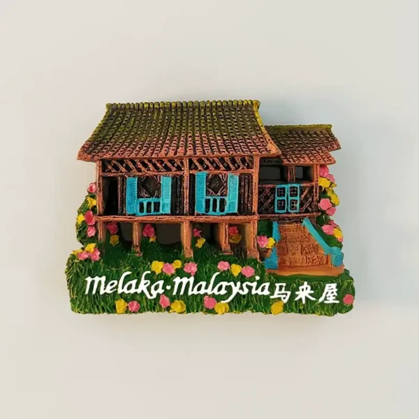 Front view of Melaka Malay stilt house 3D fridge magnet with turquoise shutters, tiled roof, and flower garden