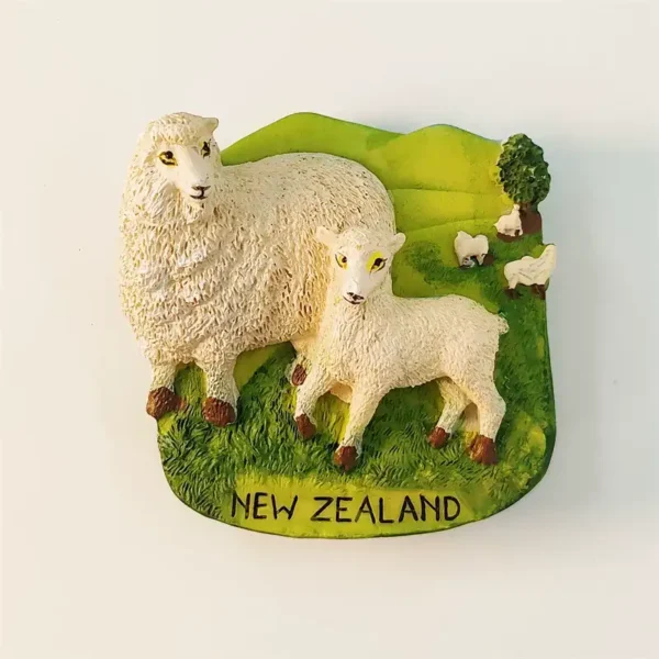 Front view of 3D New Zealand sheep fridge magnet with woolly ewe and lamb on green pasture hills