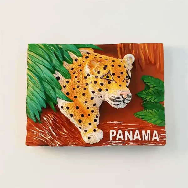 Panama jaguar 3D fridge magnet front view with golden spotted big cat emerging from green tropical leaves on rust-brown background