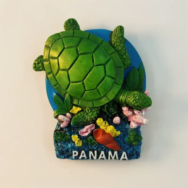 Panama fridge magnet front view showing 3D green sea turtle swimming over blue oval base with colorful coral reef pink yellow corals orange shell and PANAMA white lettering