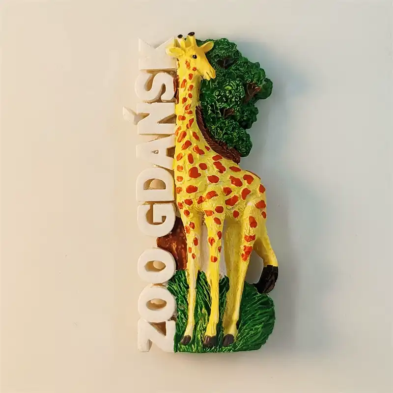 Poland Gdańsk Zoo fridge magnet front view showing 3D yellow giraffe with orange brown spots standing in lush green jungle setting with white vertical ZOO GDANSK raised lettering on left side