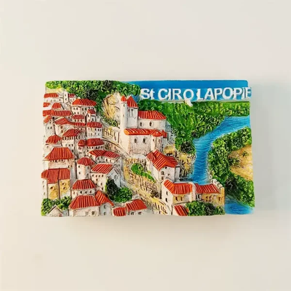Front view of Saint-Cirq-Lapopie 3D fridge magnet with red-roofed village, church tower, and Lot River