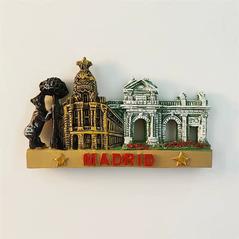 spain-madrid-fridge-magnet-bear-metropolis-puerta-alcala-front Spain Madrid fridge magnet front view showing 3D dark bronze Bear and Strawberry Tree statue left golden Metropolis Building baroque dome center and grey green Puerta de Alcala neoclassical arch right on gold base with red MADRID lettering and gold stars
