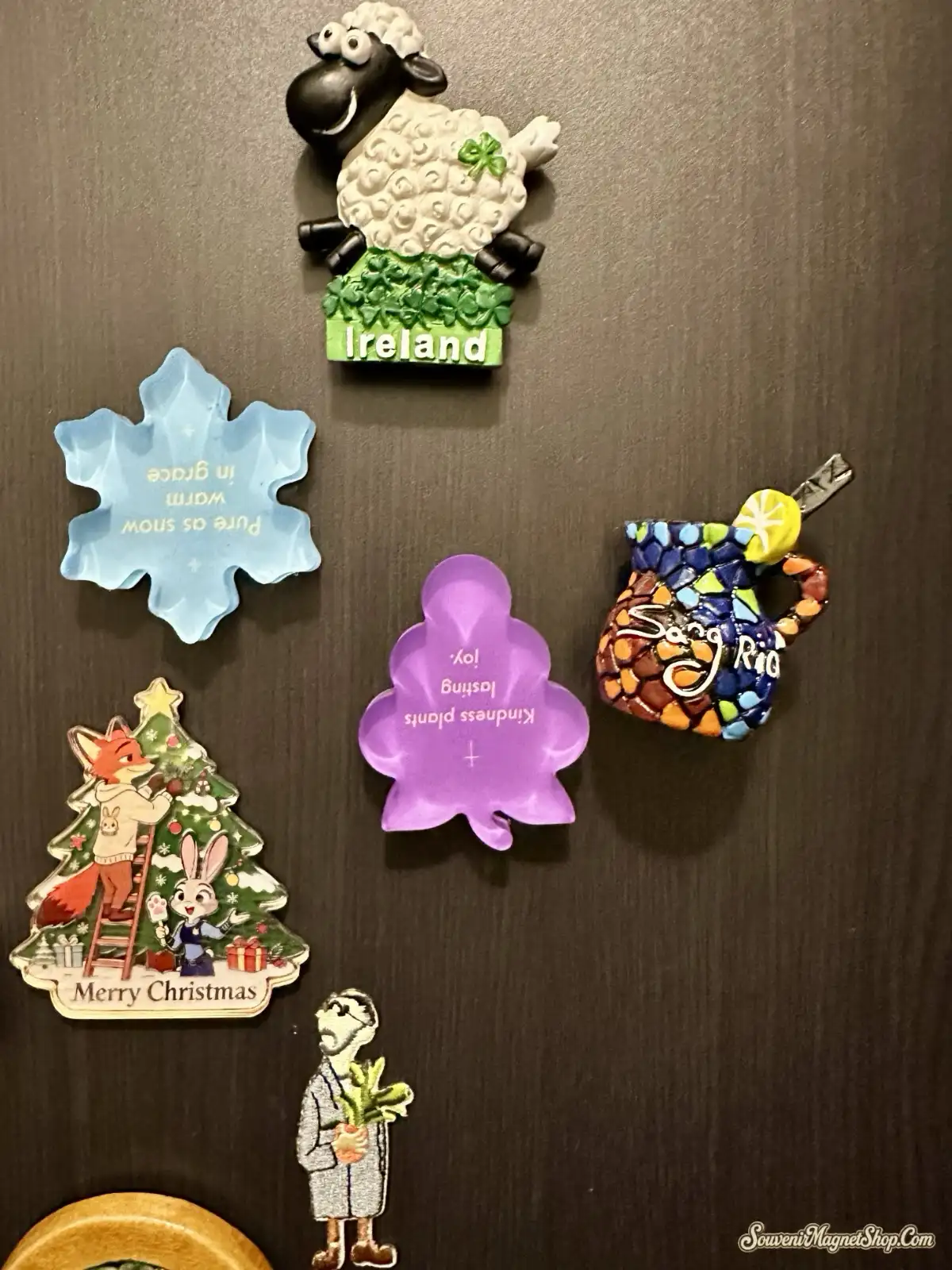 A customer shows Canada Ottawa Parliament Hill Maple Leaf Fridge Magnet on the palm of his hand