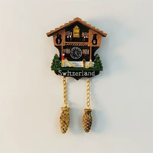 Front view of Switzerland cuckoo clock fridge magnet with Alpine chalet, Roman numeral clock and dangling pine cone chain pendants