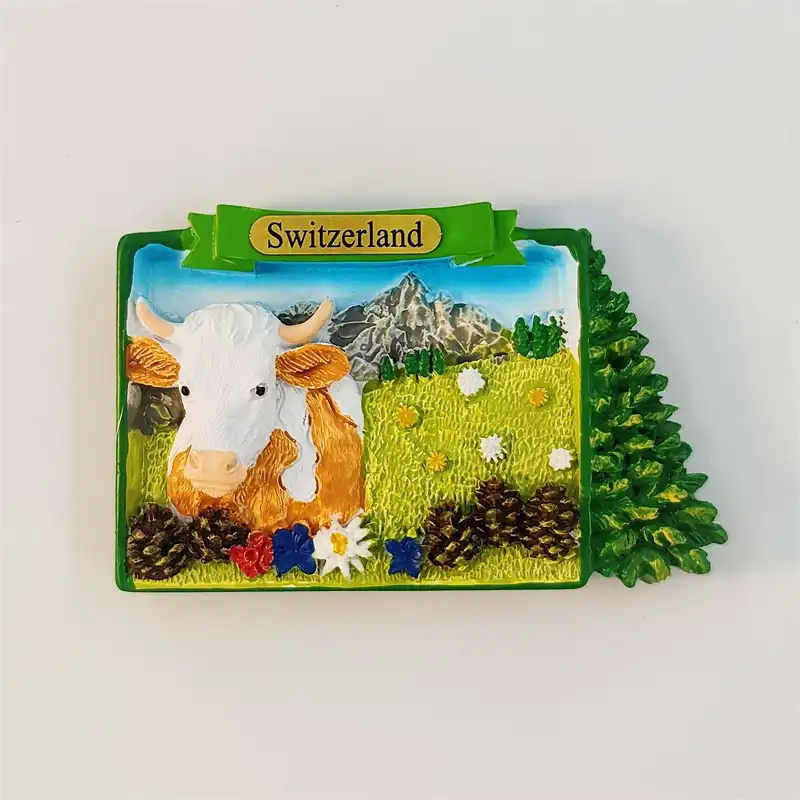Switzerland Jungfrau fridge magnet front view with hand-painted Swiss cow, alpine peaks and edelweiss flowers