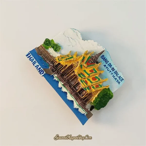 Angled left view of Bang Pa-In Palace souvenir magnet showing golden roof details and Thailand label