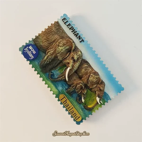 Right angled view of Thailand elephant souvenir magnet showing 3D textured elephants and tusks