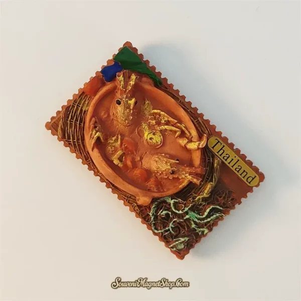 Right angled view of Thailand Tom Yum Goong souvenir magnet showing 3D shrimp and broth detail