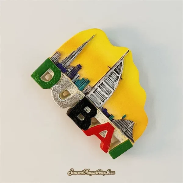 Dubai UAE souvenir fridge magnet angle view showing 3D Burj Khalifa and sail-shape tower relief