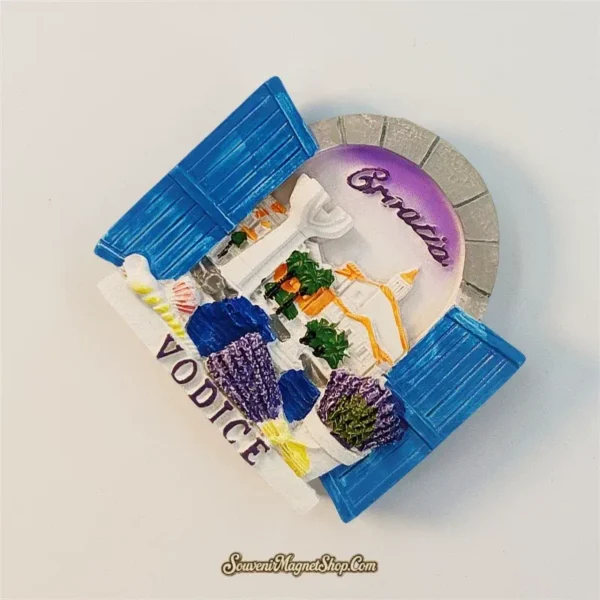 Vodice Croatia souvenir magnet angled view showing 3D blue shutters bell tower rooftops and hand-painted lavender details