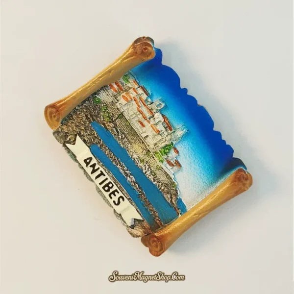 Antibes France souvenir fridge magnet top-down view showing 3D scroll shape and golden rolled edges