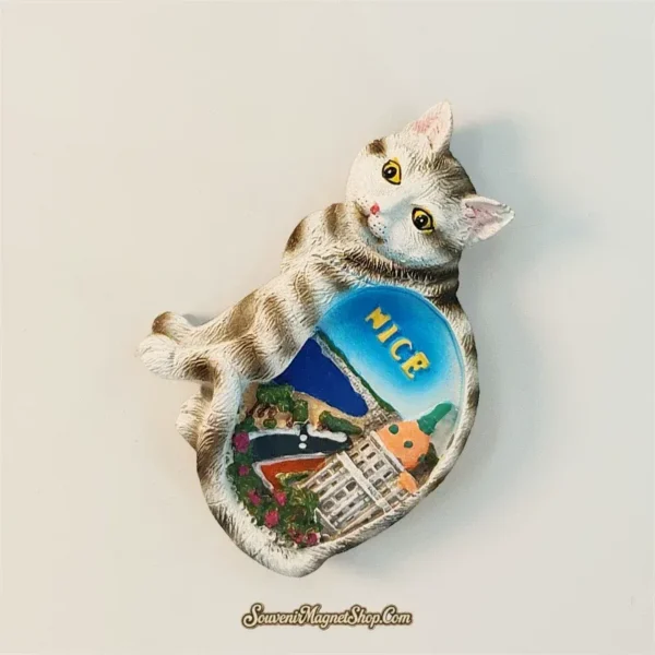 Angled Provence Nice souvenir magnet showing 3D hand-painted tabby cat with Côte d'Azur scene, pink ears and yellow eyes