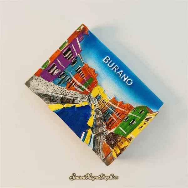 Burano rainbow houses souvenir magnet angled view showing 3D relief of Venetian canal, stone bridges and hand-painted facades