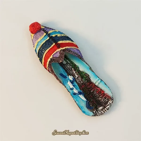 Angled view of Marmaris Aegean slipper souvenir magnet showing 3D curl-toe shape and folk-pattern stripes