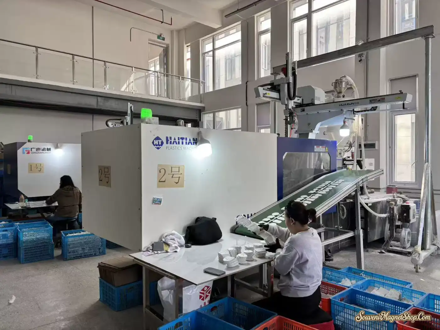 HAITIAN plastic injection molding machines producing the substrate bases for our souvenir fridge magnets — in-house plate-making, no outsourced components.