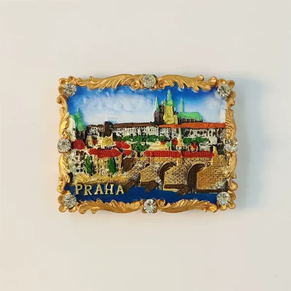Prague Charles Bridge fridge magnet front view with Prague Castle skyline, red rooftops and ornate gold baroque rhinestone frame