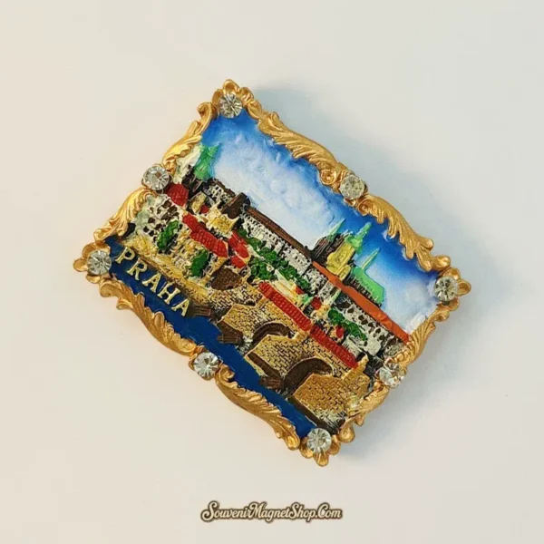Angled Prague souvenir magnet showing 3D hand-painted Charles Bridge, Prague Castle and decorative gold baroque border