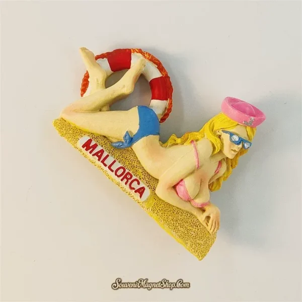 Mallorca beach girl souvenir magnet angled view showing 3D bikini figurine, pink sailor cap, sunglasses and striped Mediterranean life ring