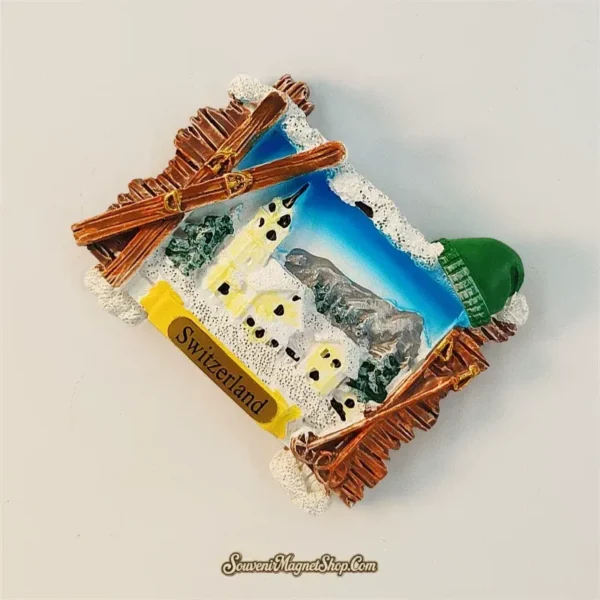 Switzerland souvenir magnet angled view showing 3D wood-grain frame, alpine village and Jungfrau ridge in the background