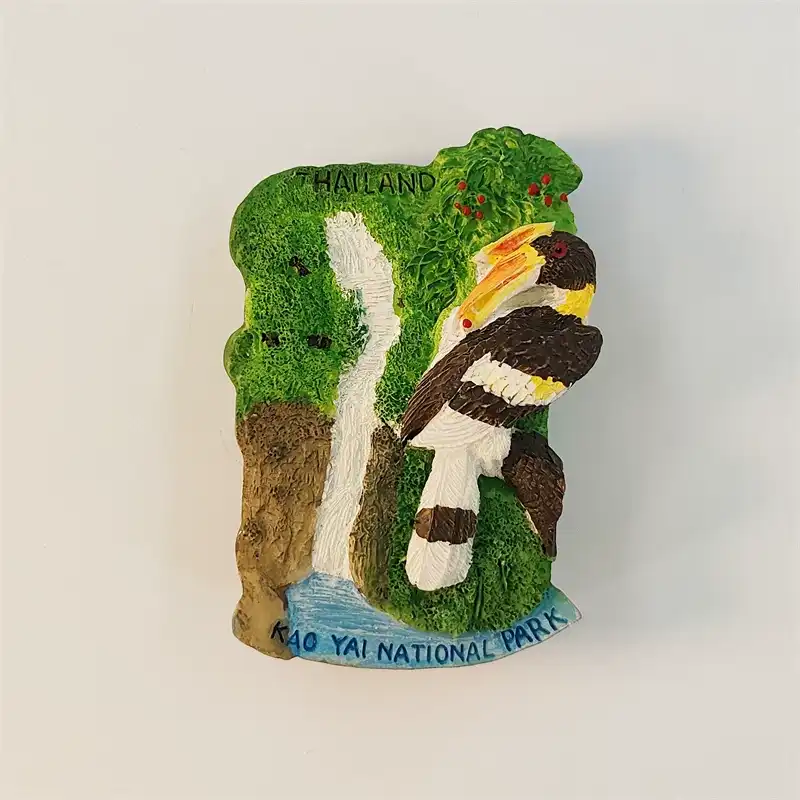 Front view of Thailand Khao Yai National Park fridge magnet with 3D hornbill, white waterfall and green jungle on a vertical resin base