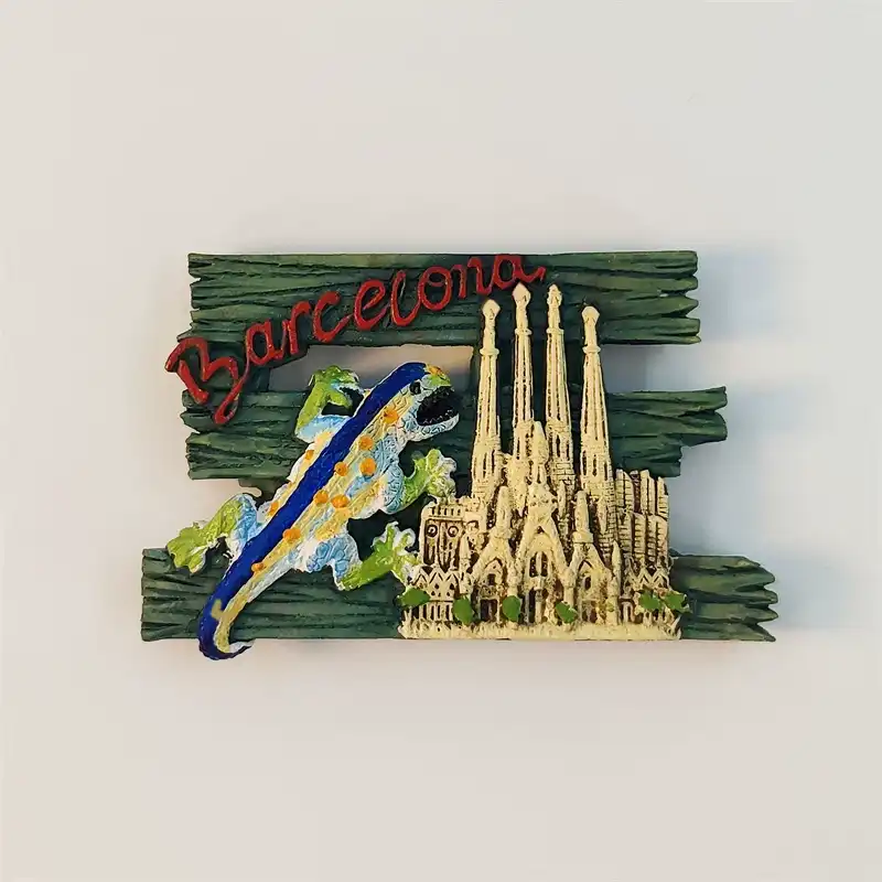 Front view of Barcelona fridge magnet with Gaudí mosaic lizard and Sagrada Família on green wood