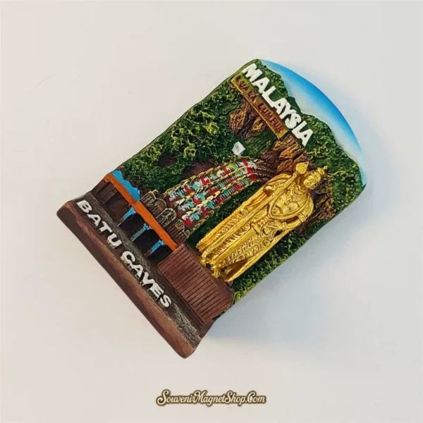 Angled view of Batu Caves souvenir magnet showing Murugan statue and colourful staircase