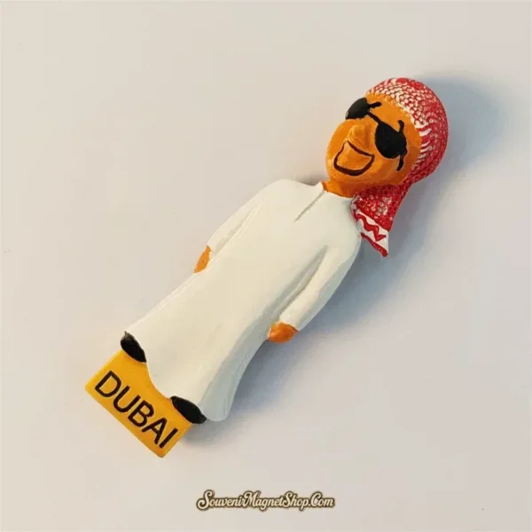 Dubai souvenir magnet of smiling Emirati man in white thobe shown at an angle, 3D hand-painted detail