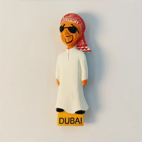 Dubai fridge magnet of hand-painted Emirati man in white robe and red keffiyeh, front view