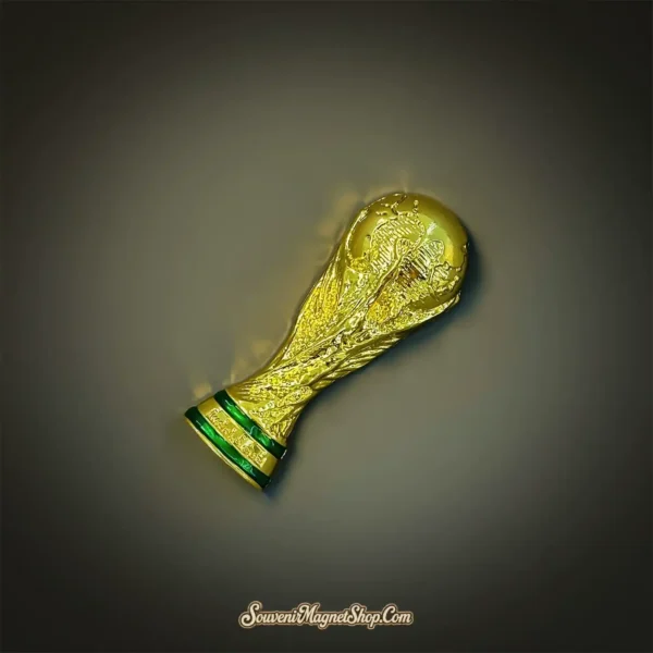 FIFA World Cup Trophy souvenir magnet angled view showing 3D gold relief sculpture detail