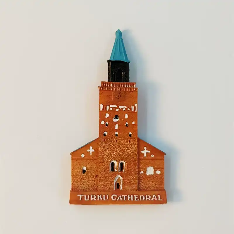 Front view of a Finland Turku Cathedral fridge magnet with terracotta walls and a teal spire