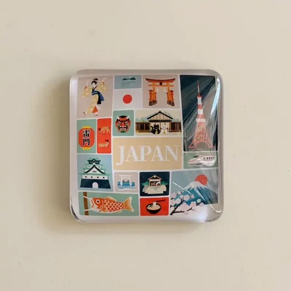 Front view of a Japan icons crystal glass fridge magnet with a colorful collage of Mt Fuji, Tokyo Tower, torii gate and geisha