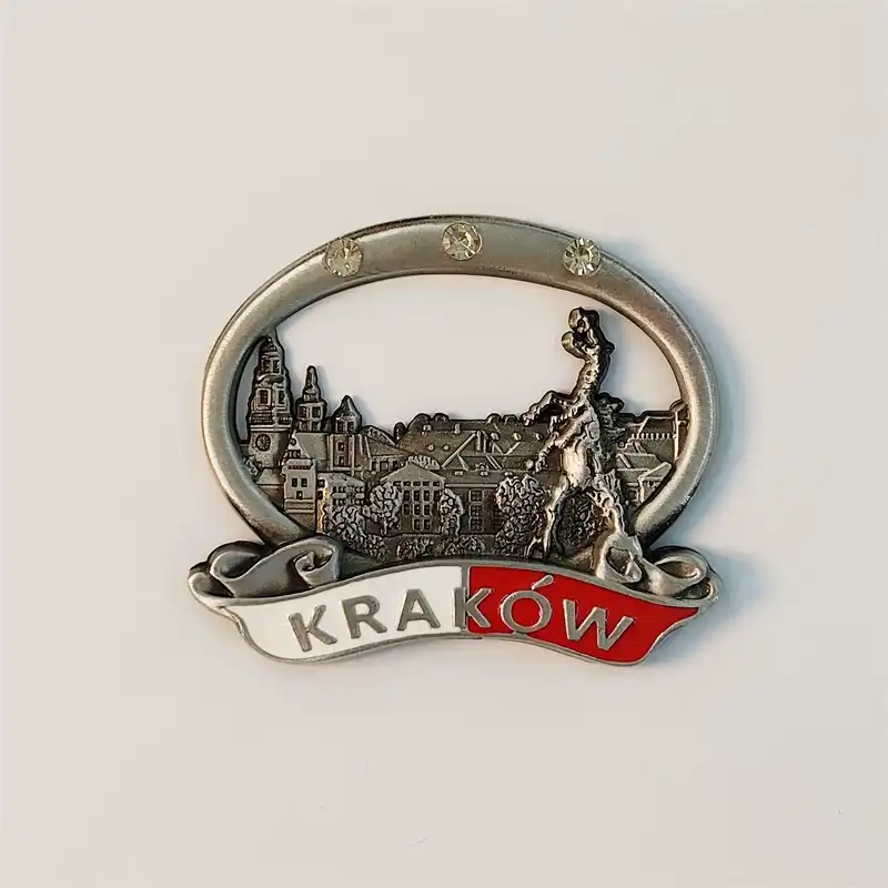 Front view of a Poland Krakow Wawel Castle metal fridge magnet with crystal-studded oval frame and red-white Krakow banner